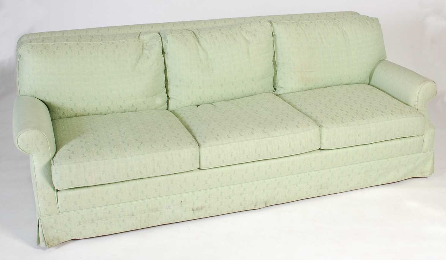 Lot 12 - A green upholstered three seat sofa with loose...