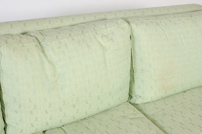 Lot 12 - A green upholstered three seat sofa with loose...