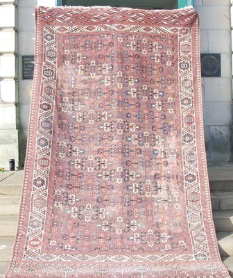 Lot 863 - A Persian madder ground carpet, the...