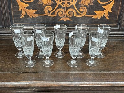 Lot 479C - A set of nine cut glass champagne flutes,...