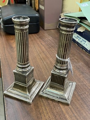 Lot 118B - A pair of white metal pillar candlesticks,...