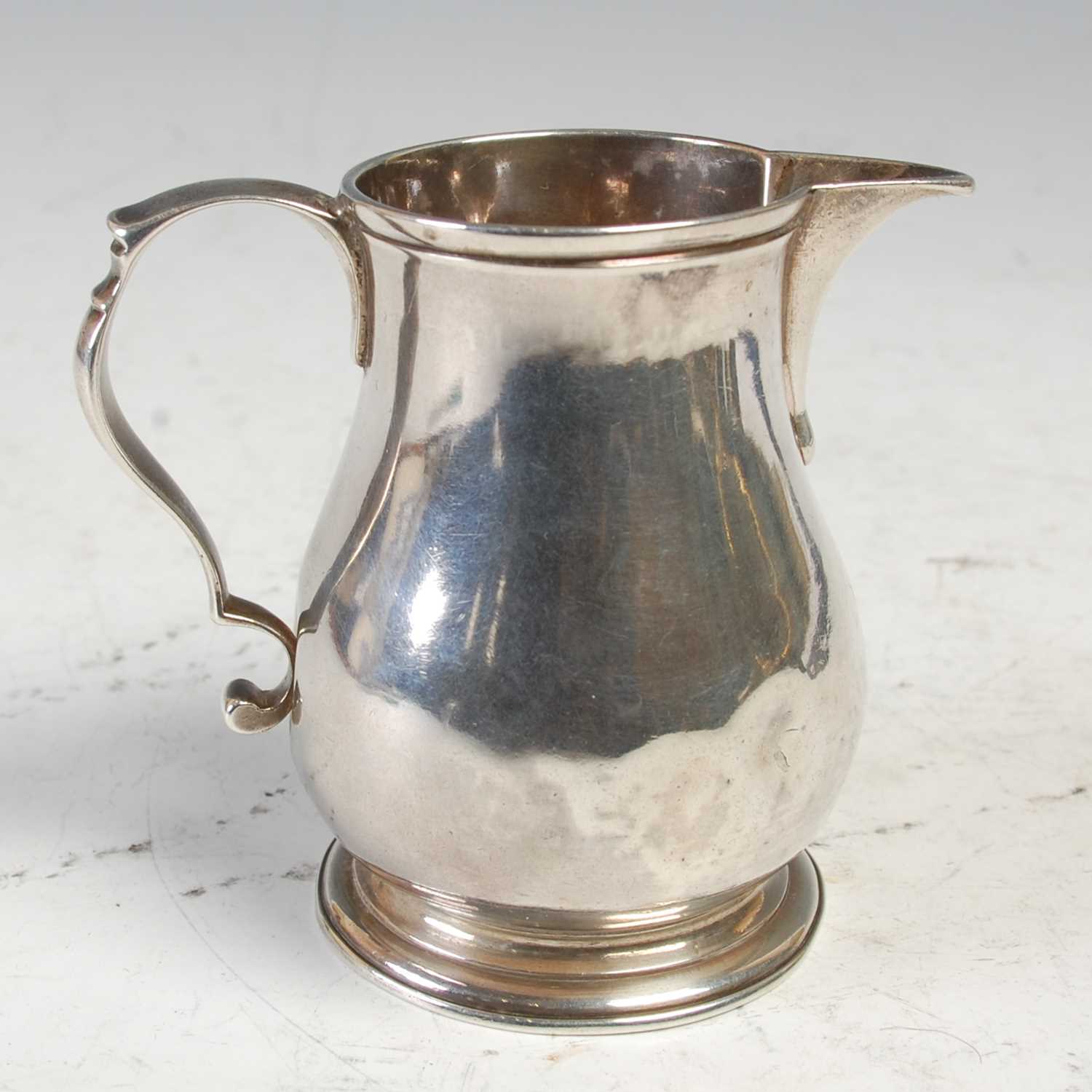 Lot 484 - A George II silver ‘sparrow beak’ cream jug,...