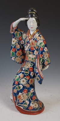 Lot 832 - A Japanese Imari porcelain figure of a Bijin,...