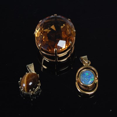 Lot 574 - A group of three yellow metal mounted pendants,...