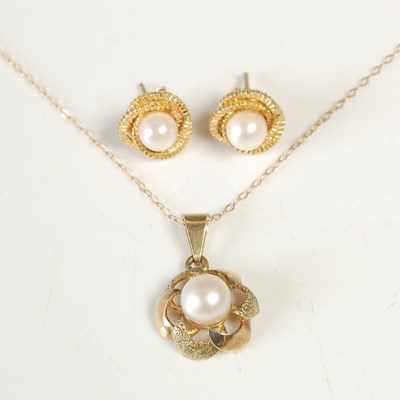 Lot 554 - A 9ct gold and pearl set pendant suspended on...