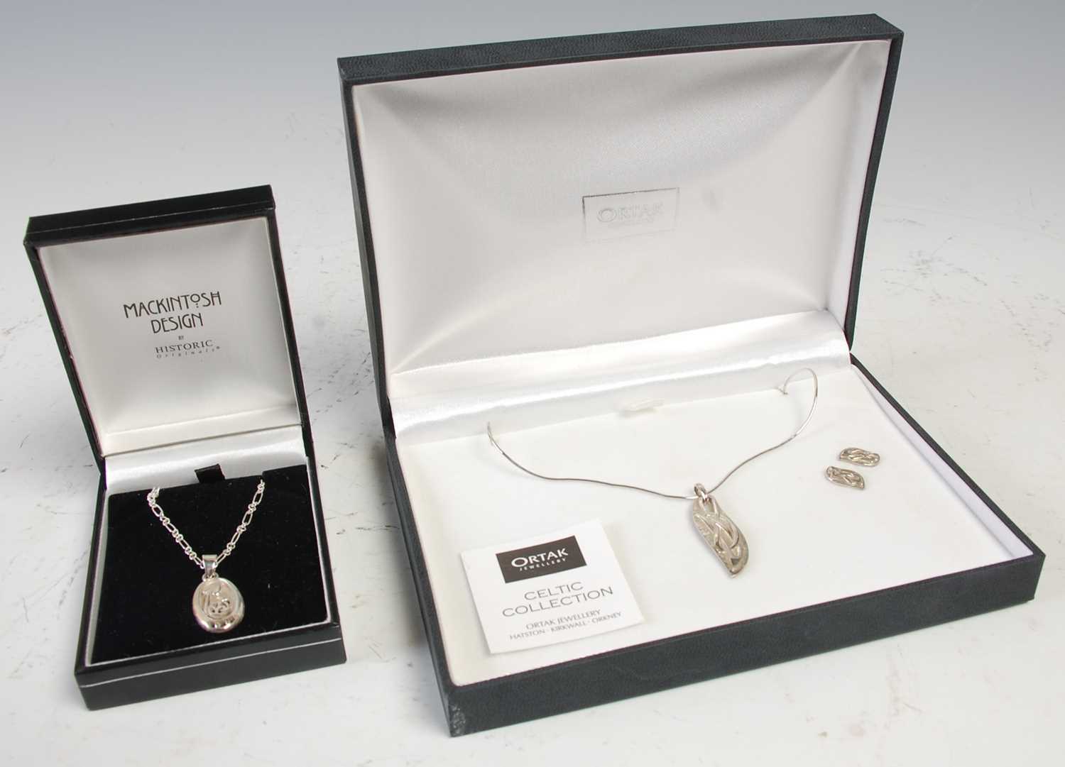 Lot 566 - A cased Ortak silver Celtic Collection pendant...