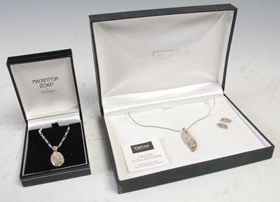 Lot 566 - A cased Ortak silver Celtic Collection pendant...