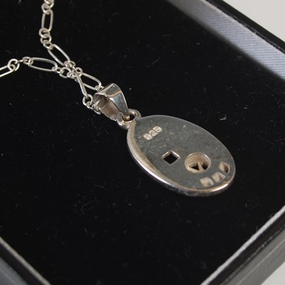 Lot 566 - A cased Ortak silver Celtic Collection pendant...