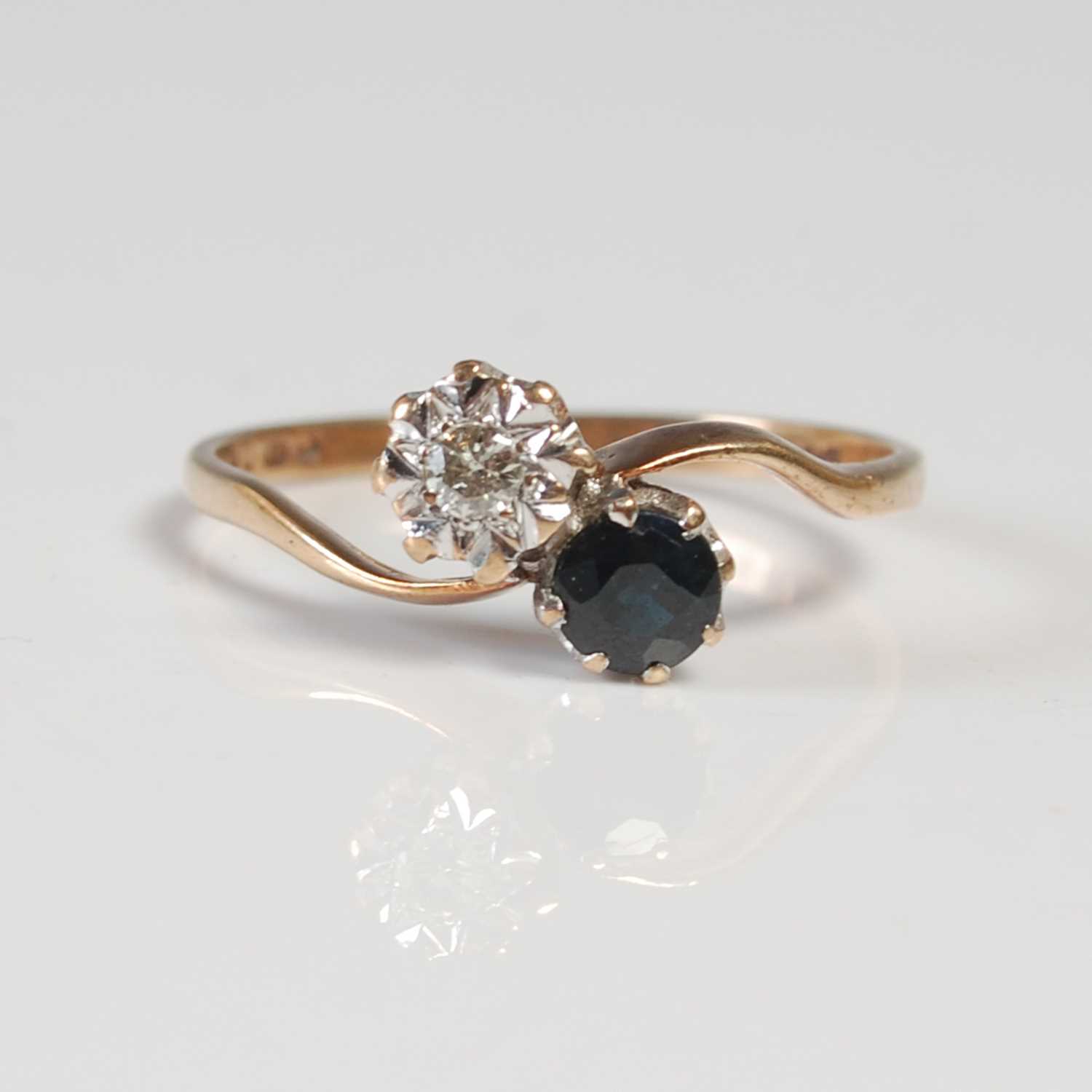 Lot 622 - A 9ct gold, diamond and sapphire two stone...