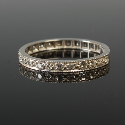Lot 646 - A white metal and diamond chip eternity...