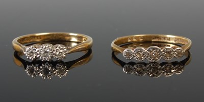 Lot 588 - A yellow and white metal three stone gem set...