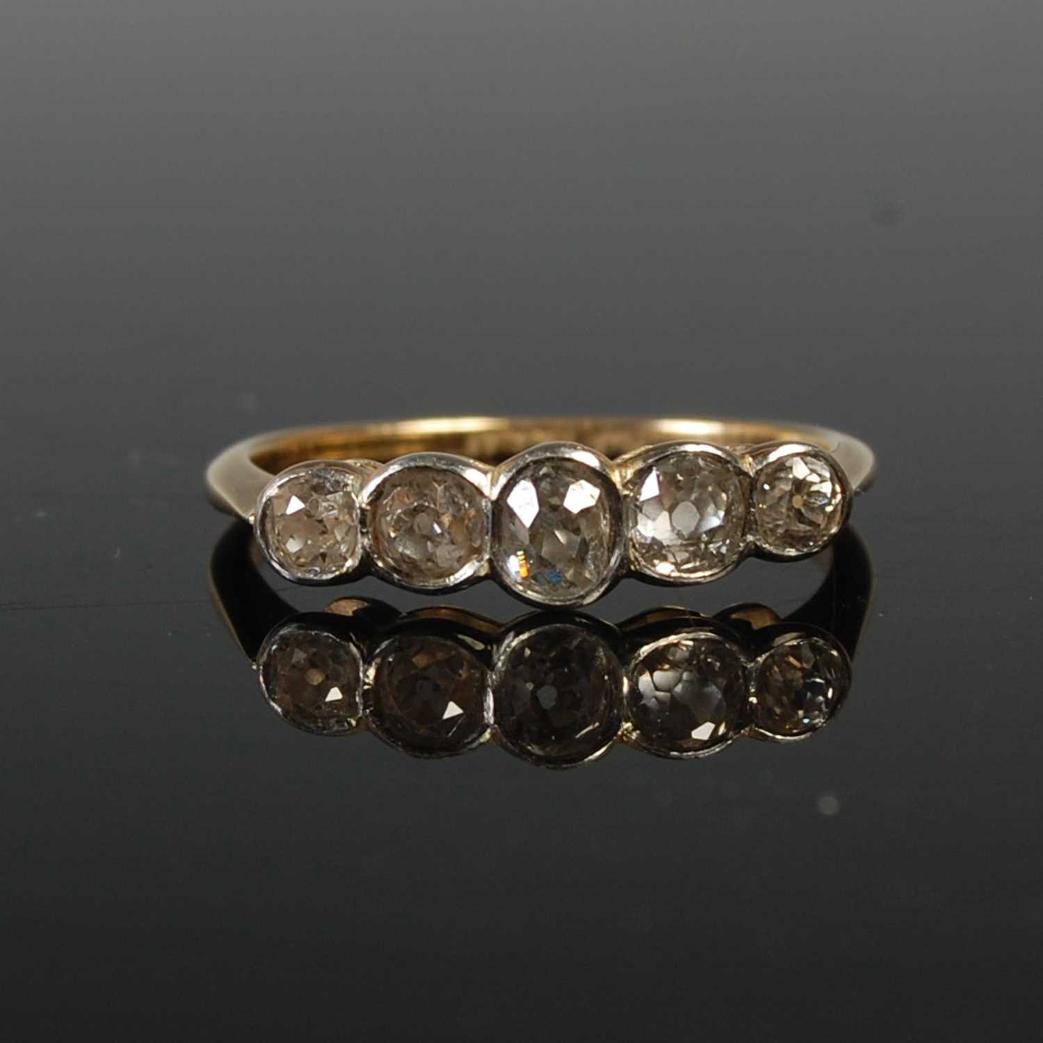 Lot 655 - A yellow metal and diamond five stone ring,...