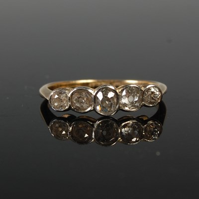 Lot 655 - A yellow metal and diamond five stone ring,...