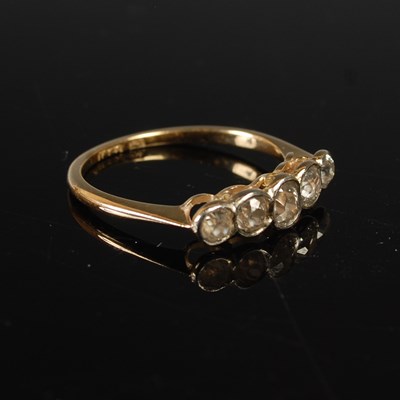 Lot 655 - A yellow metal and diamond five stone ring,...