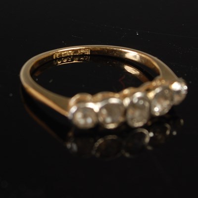 Lot 655 - A yellow metal and diamond five stone ring,...