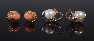 Lot 605 - A pair of yellow metal and coral set ear studs,...