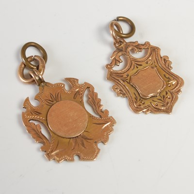 Lot 639 - Two 9ct gold shield shaped pendants, gross...