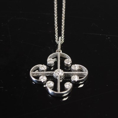 Lot 670 - A 9ct white gold diamond chip pendant and...