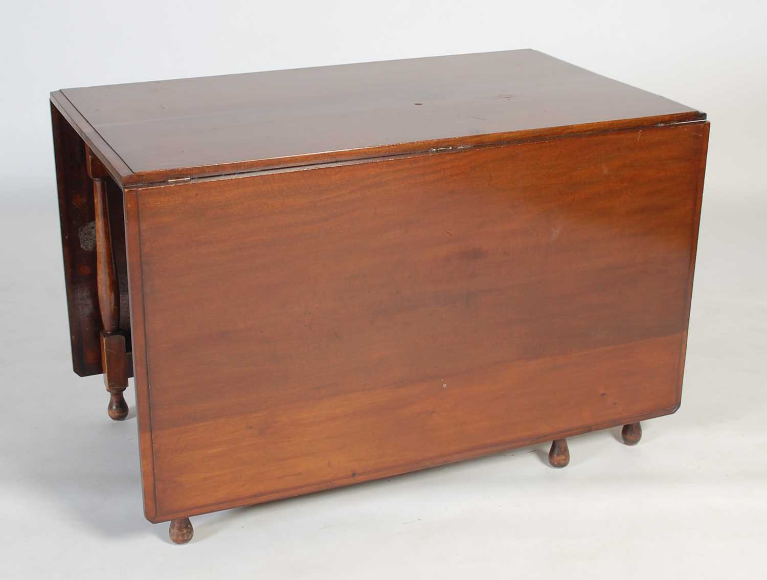 Lot 5 - An early 20th century drop-leaf dining table,...