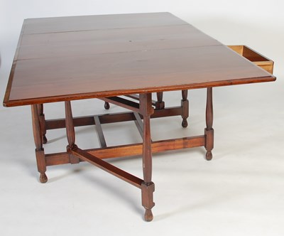 Lot 5 - An early 20th century drop-leaf dining table,...