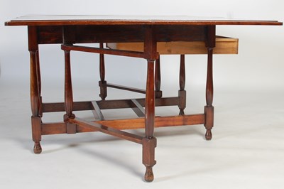 Lot 5 - An early 20th century drop-leaf dining table,...