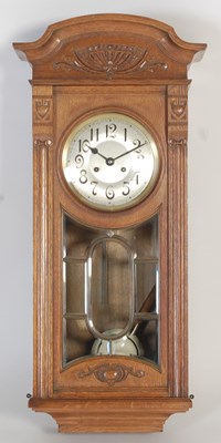 Lot 292 - An early 20th century oak wall clock, the...
