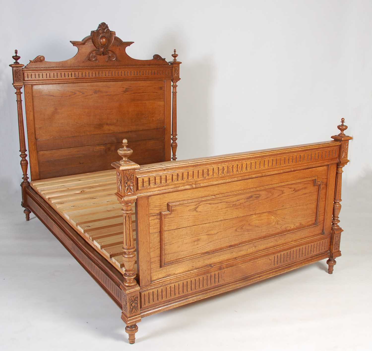 Lot 60 - An early 20th century oak double bed, the...