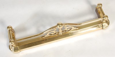 Lot 241 - A small sized brass fire fender, with upright...