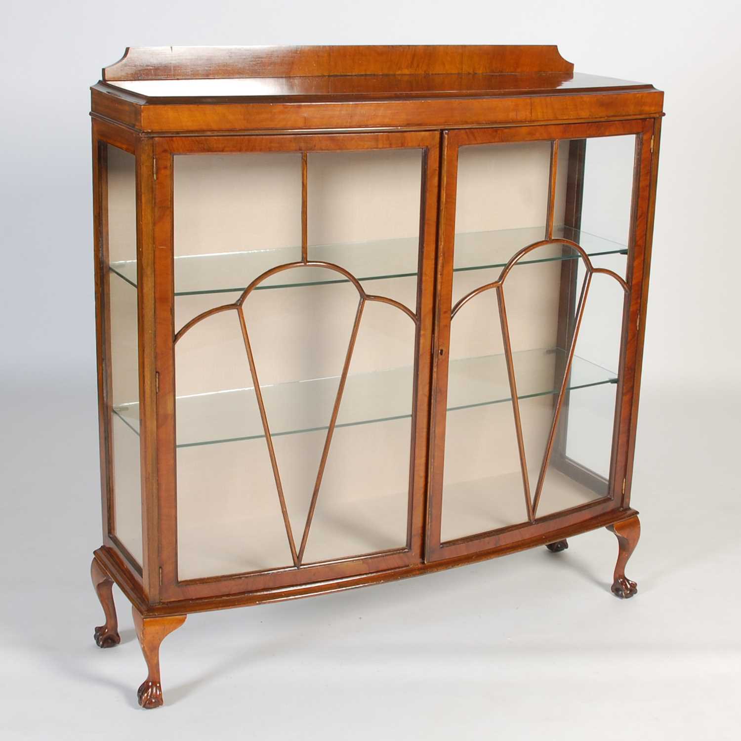Lot 50 - An early 20th century walnut bowfront display...