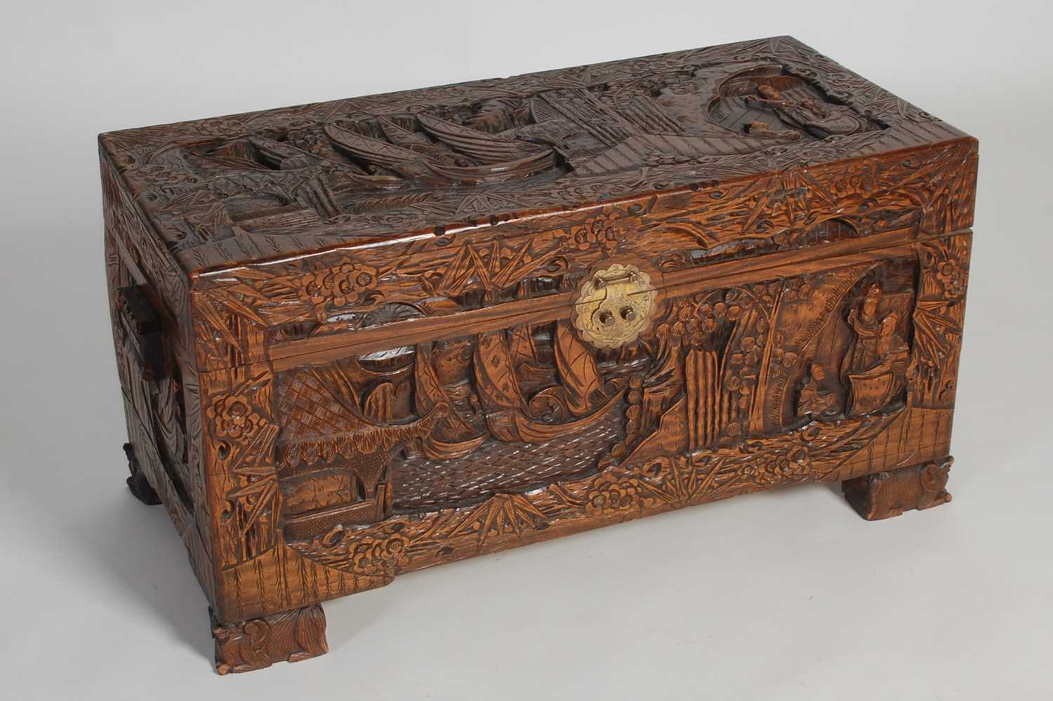 Lot 34 - A Chinese camphorwood blanket box, carved in...
