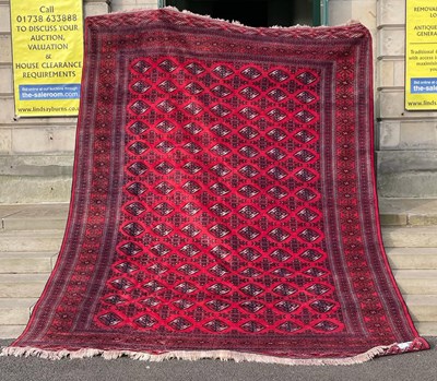 Lot 163 - A Persian Turkoman carpet, the rectangular red...