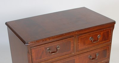 Lot 26 - A reproduction mahogany chest of two short...