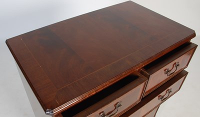 Lot 26 - A reproduction mahogany chest of two short...