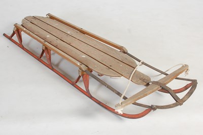 Lot 235 - A vintage wood and metal sledge, 134cm long.