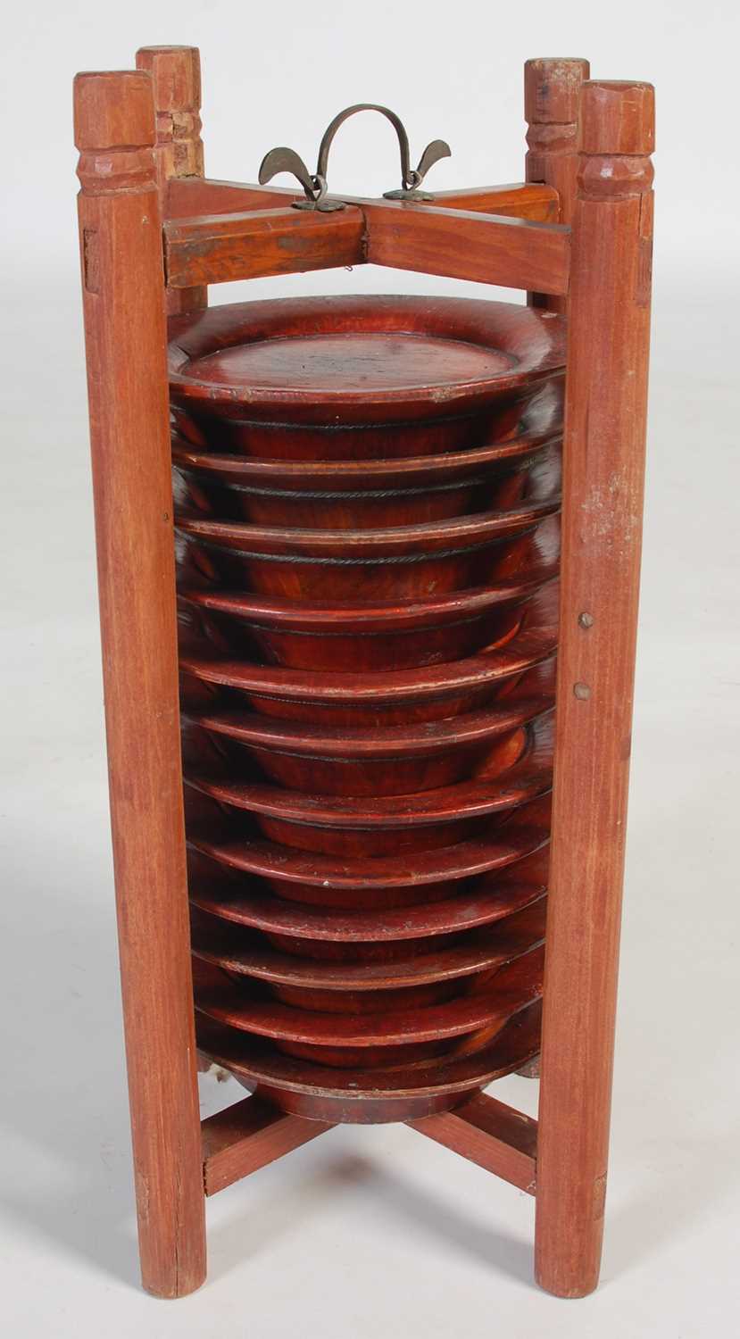 Lot 821 - A Chinese wooden plate holder, containing...