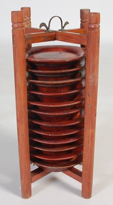 Lot 821 - A Chinese wooden plate holder, containing...