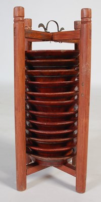 Lot 821 - A Chinese wooden plate holder, containing...