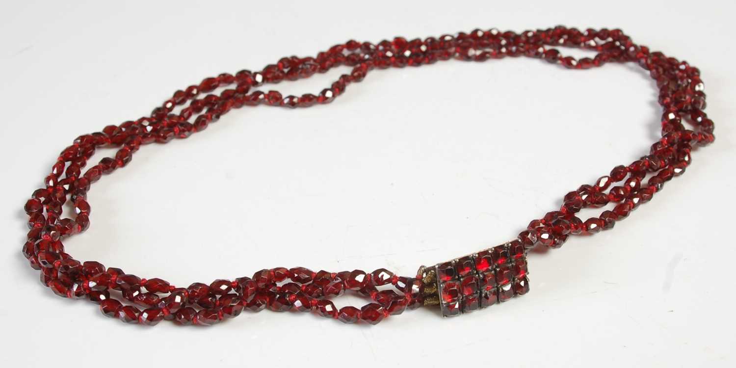 Lot 565 - An antique garnet three strand necklace, with...