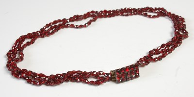 Lot 565 - An antique garnet three strand necklace, with...