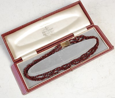 Lot 565 - An antique garnet three strand necklace, with...