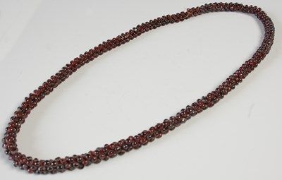 Lot 673 - A garnet multi bead single strand necklace,...