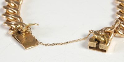Lot 595 - A yellow metal curb-link bracelet, the clasp...