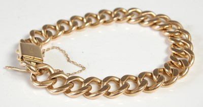 Lot 595 - A yellow metal curb-link bracelet, the clasp...