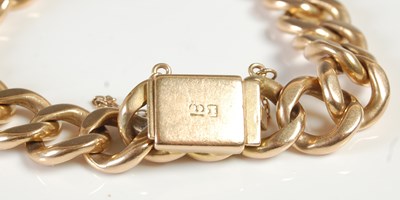Lot 595 - A yellow metal curb-link bracelet, the clasp...