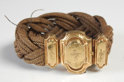 Lot 557 - A yellow metal mounted woven and braided...