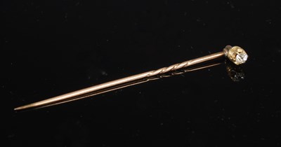 Lot 613B - A yellow metal and diamond stick pin, 68.3mm...