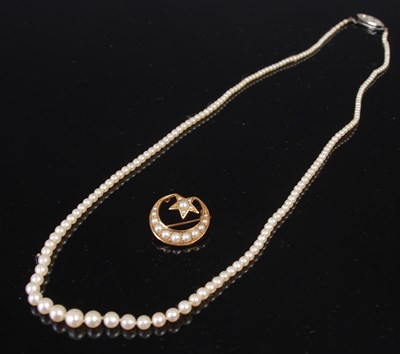 Lot 613C - A single strand pearl necklace and a yellow...