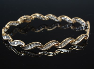 Lot 644D - A yellow metal and diamond set bracelet, set...