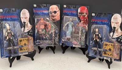 Lot 673 - Four NECA Reel Toys sealed Hellraiser figures...