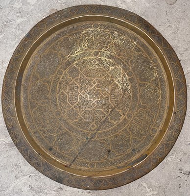 Lot 557 - A Middle Eastern brass circular tray, with...